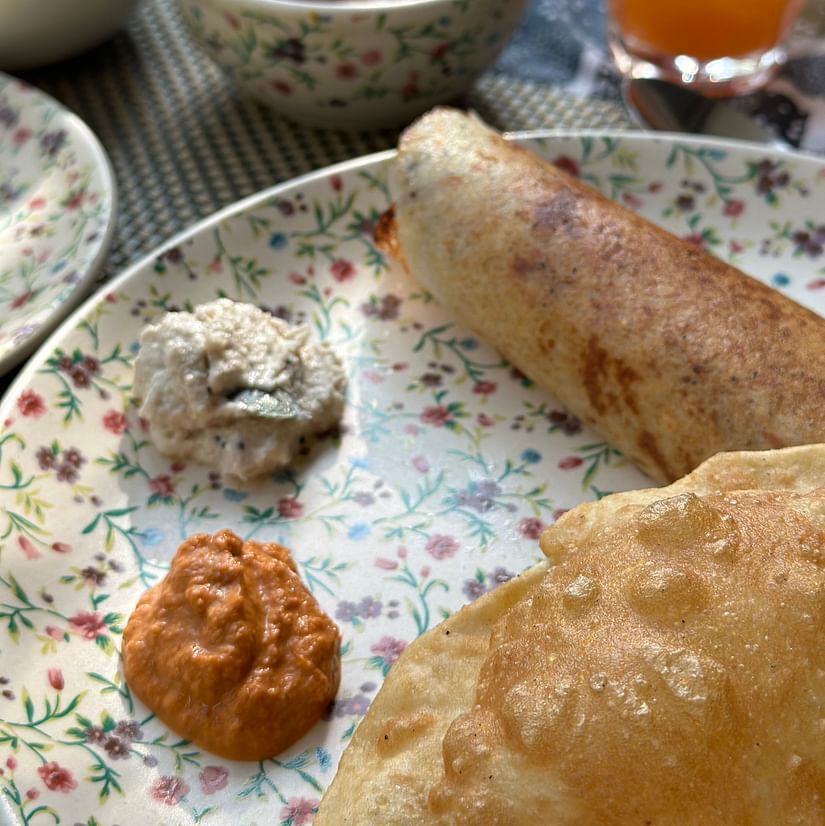 Image of various south indian dishes plated a plate and kept on a table