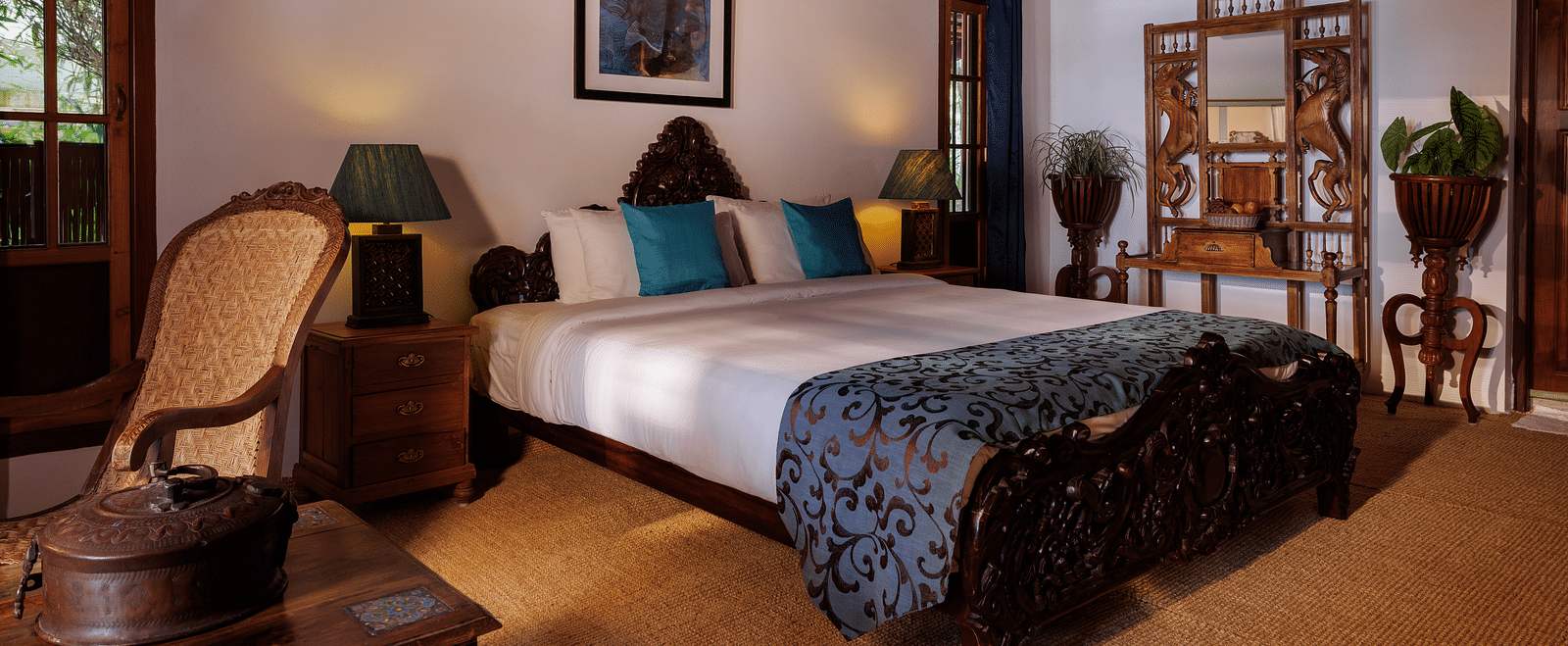 A room with a bed, a wooden dresser, a chair, and a coffee table - BluSalzz Villas - Muhamma Resort, Alleppey