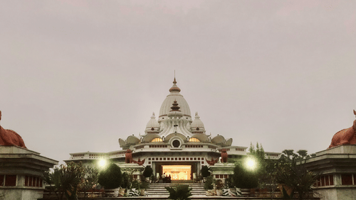 A temple with a long, scenic walking entrance leading up to the main structure.