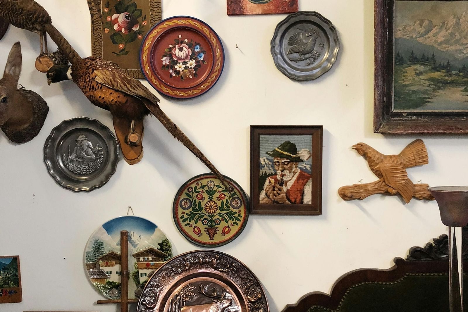 image featuring various wall hung artefacts on a white coloured wall in a museum