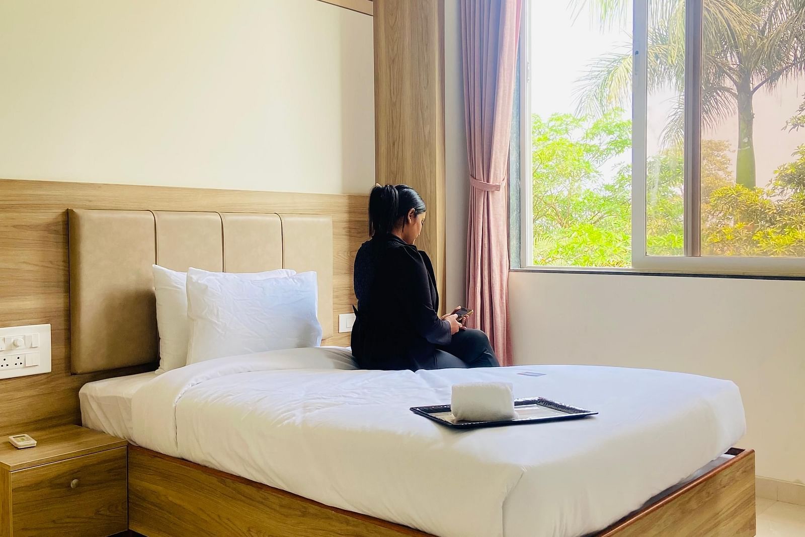 A modern hotel room with a seating area by the window and elegant decor at Lotus Leaf Boutique Hotel.