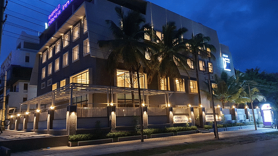 Hotel exterior in night sky with warm lighting around