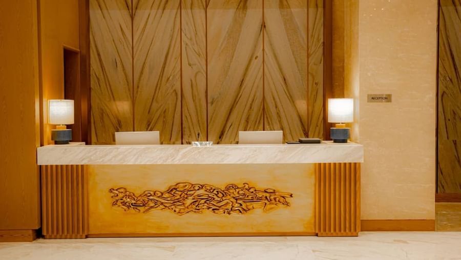 Frontal capture of reception desk with golden floral design at our hotel in Hargeisa - Serene Sarovar Premiere Hargeisa