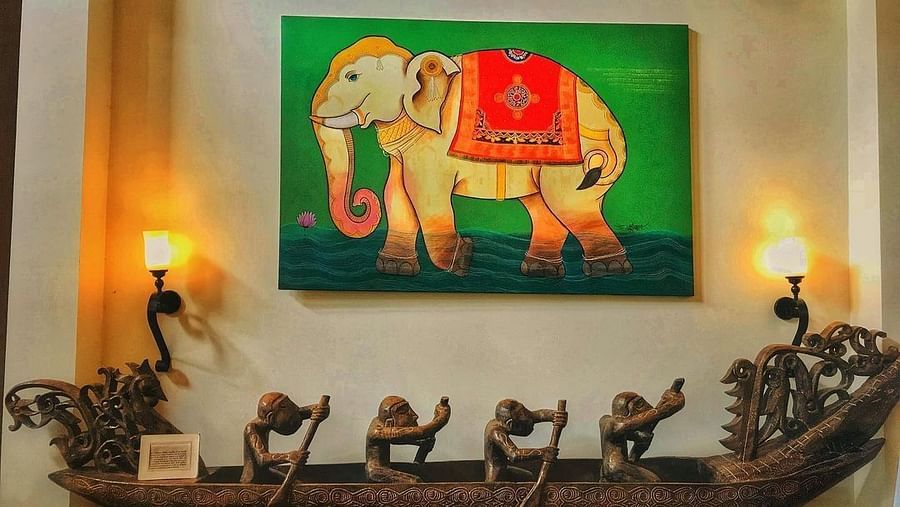 Painting of an elephant and people rowing a wooden boat decor beneath - Rhythm Lonavala