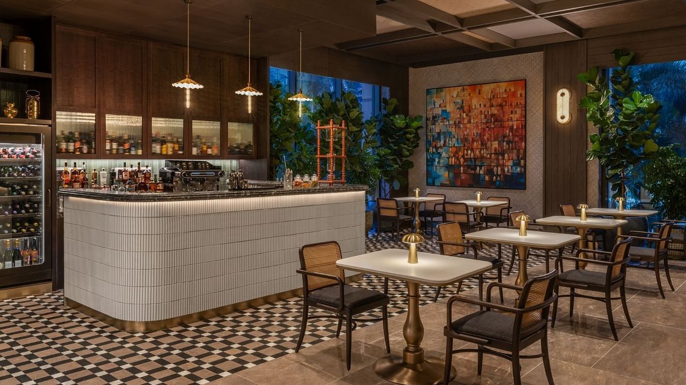 Dining area with warm ambiance and soft dim lighting at The Residency Towers Chennai, offering a cozy and inviting atmosphere.
