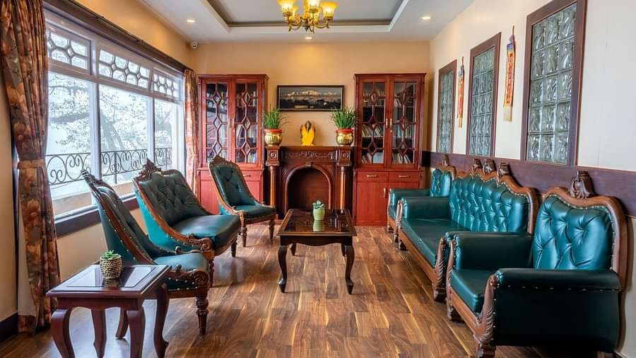 Multiple chairs and a coffee table placed in a room with a glass window | Summit Oakden Resort & Spa, Mall Road