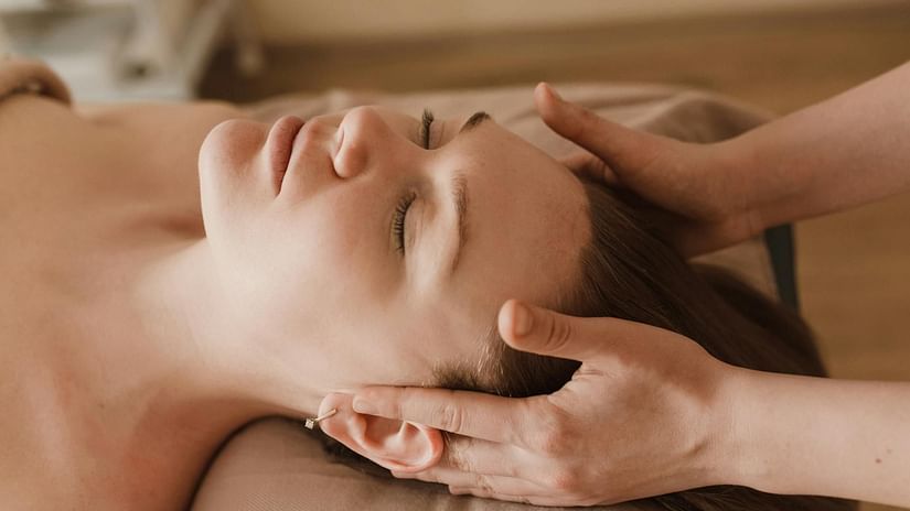 a person laying down with head on a pillow to do swedish massage in mumbai