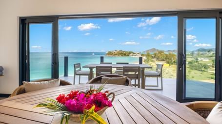 A beautiful al fresco dining area with a stunning view of the turquoise sea and distant hills - Tamarind Hills Resort and Villas - Antigua
