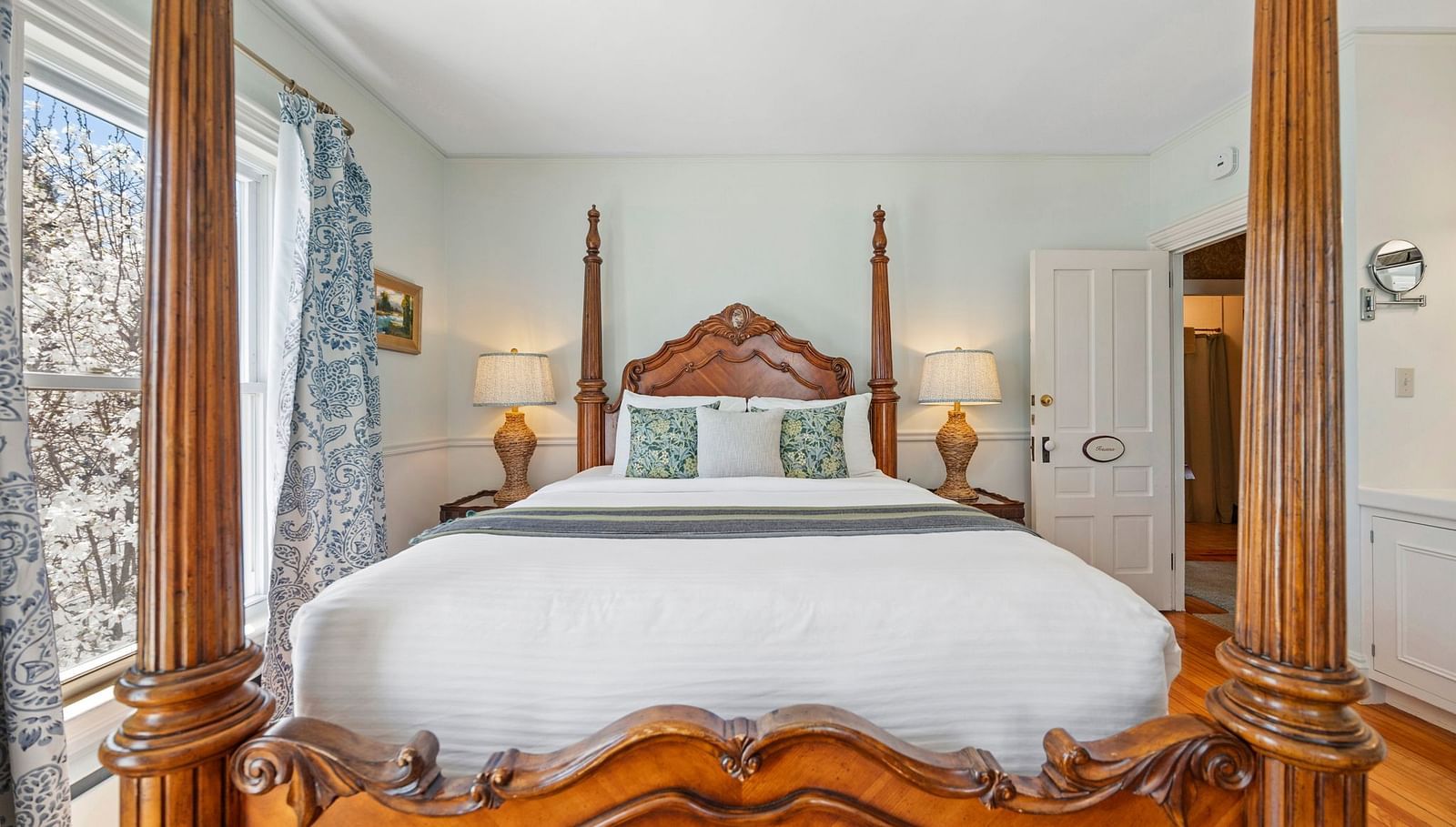 Room with ornate four-poster bed and classic decor at Hartstone Inn.