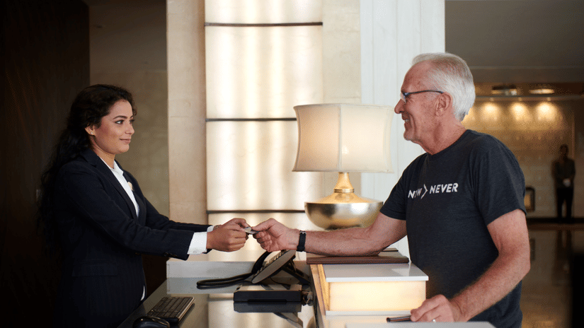 A person checking in at the front desk.