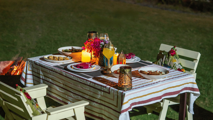 Chairs placed around a table with eatables on it at Neer Ganga.