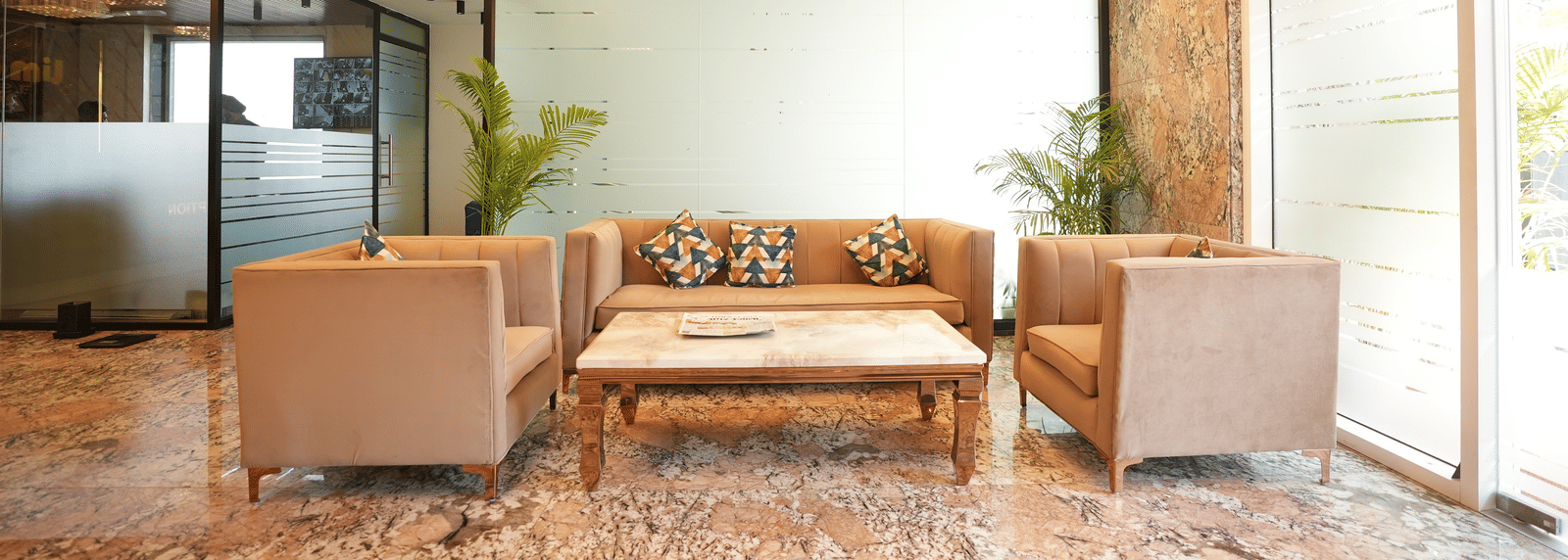 Lounge with sofas and warm lighting at Lime Tree Hotel Near India Expo Mart, Greater Noida.