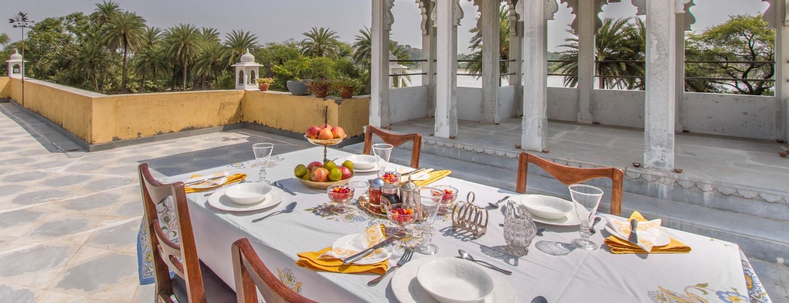 image of the Outdoor dining arrangement at Dev Shree, Deogarh overlooking beautiful views from the terrace