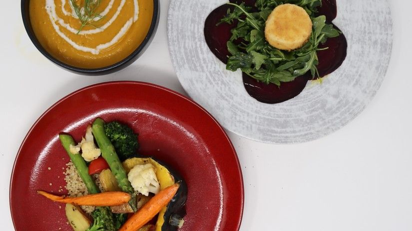 A three-course meal with a bowl of soup, a beet salad with a center medallion, and a plate of roasted vegetables at YO1 Longevity & Health Resorts