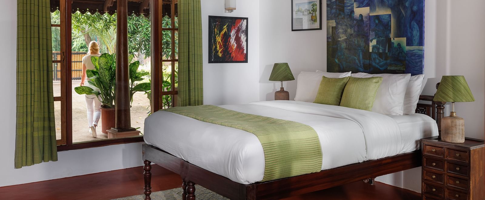 A room with a bed, wooden decorative items, and a glass window overlooking the view - BluSalzz Villas - Muhamma Resort, Alleppey