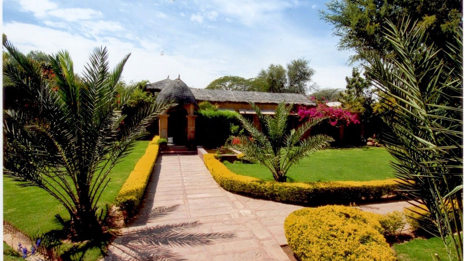 A facade image of the Taasli Restaurant at Manvar Shergarh with well maintained gardens and greenery - Manvar Resort & Desert Camp