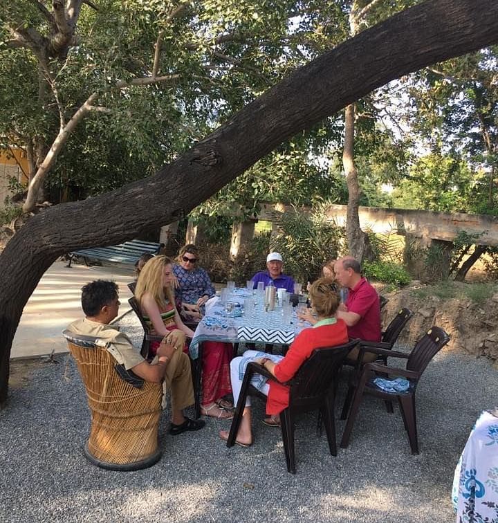 People enjoying a meal in the field - Dev Shree, Deogarh