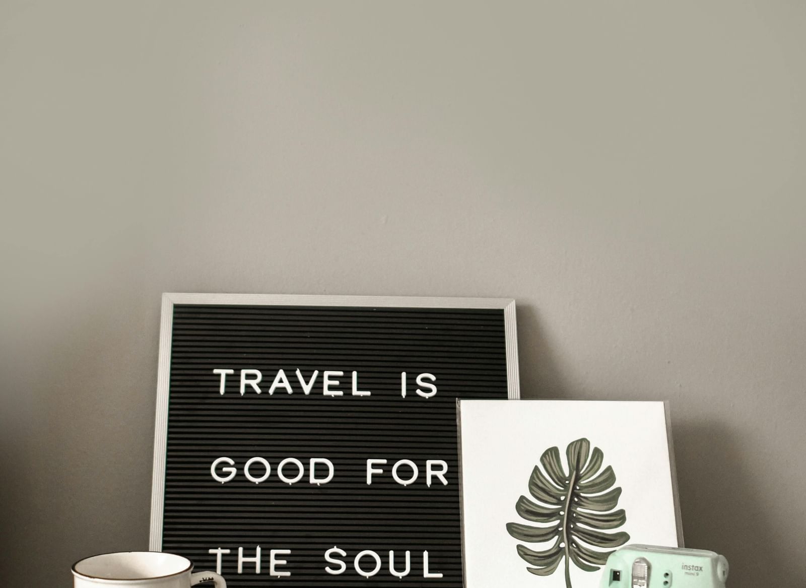 Image of a black board that talks about a travel with a polaroid camera.