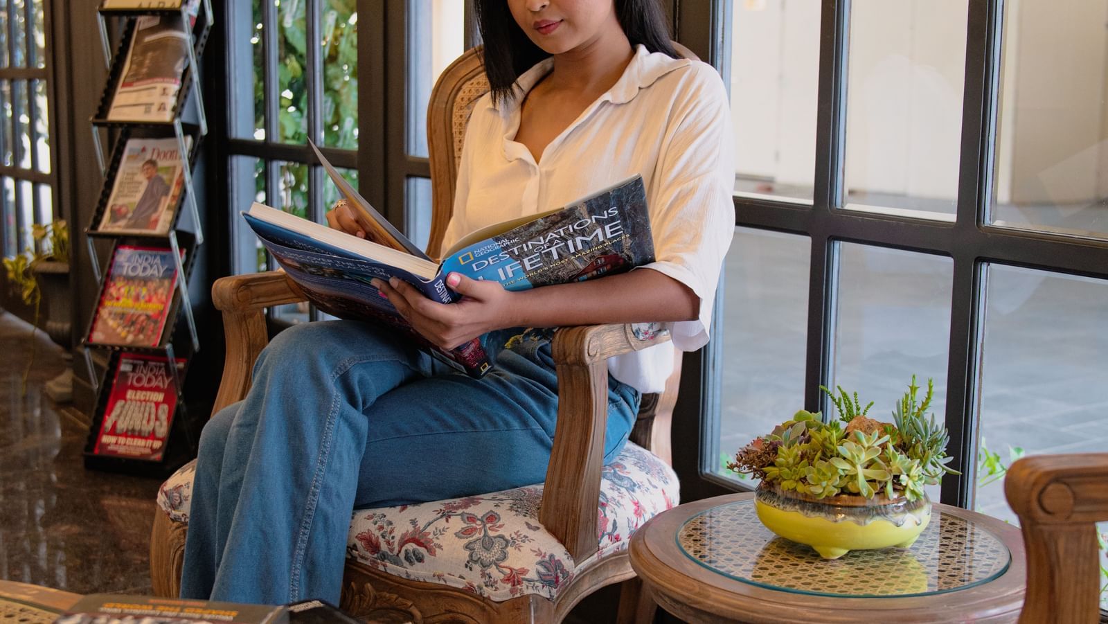 customer reading books in lobby area of the best hotel in dehradun :manor house hotels