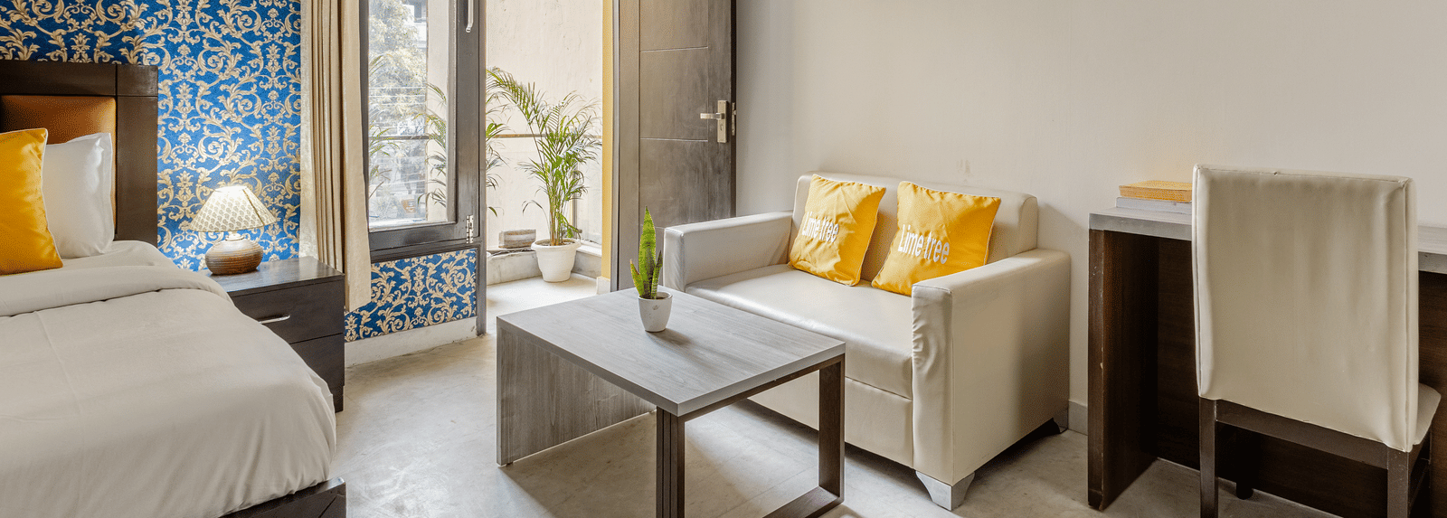 Room view with sofa and entry to balcony at Lime Tree