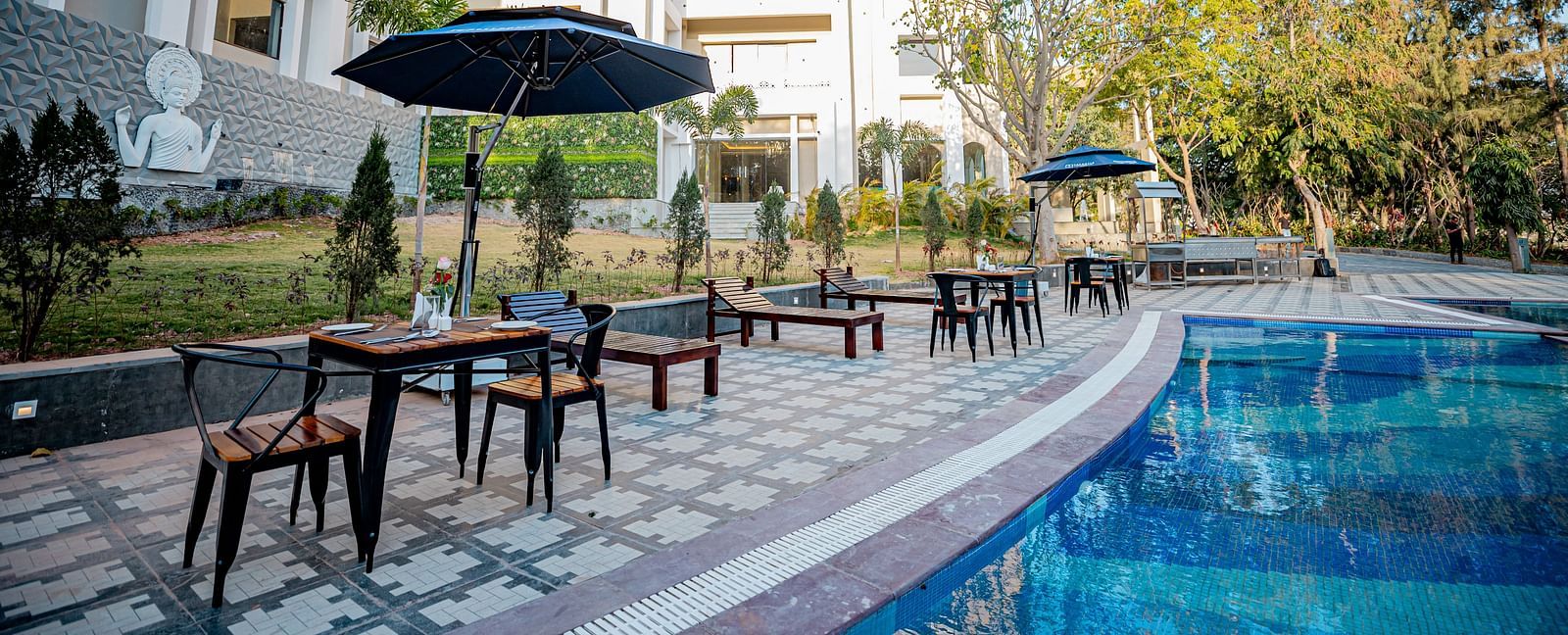 Image of a pool with seating area on the side at Essentia Luxury Resort and Spa, Udaipur