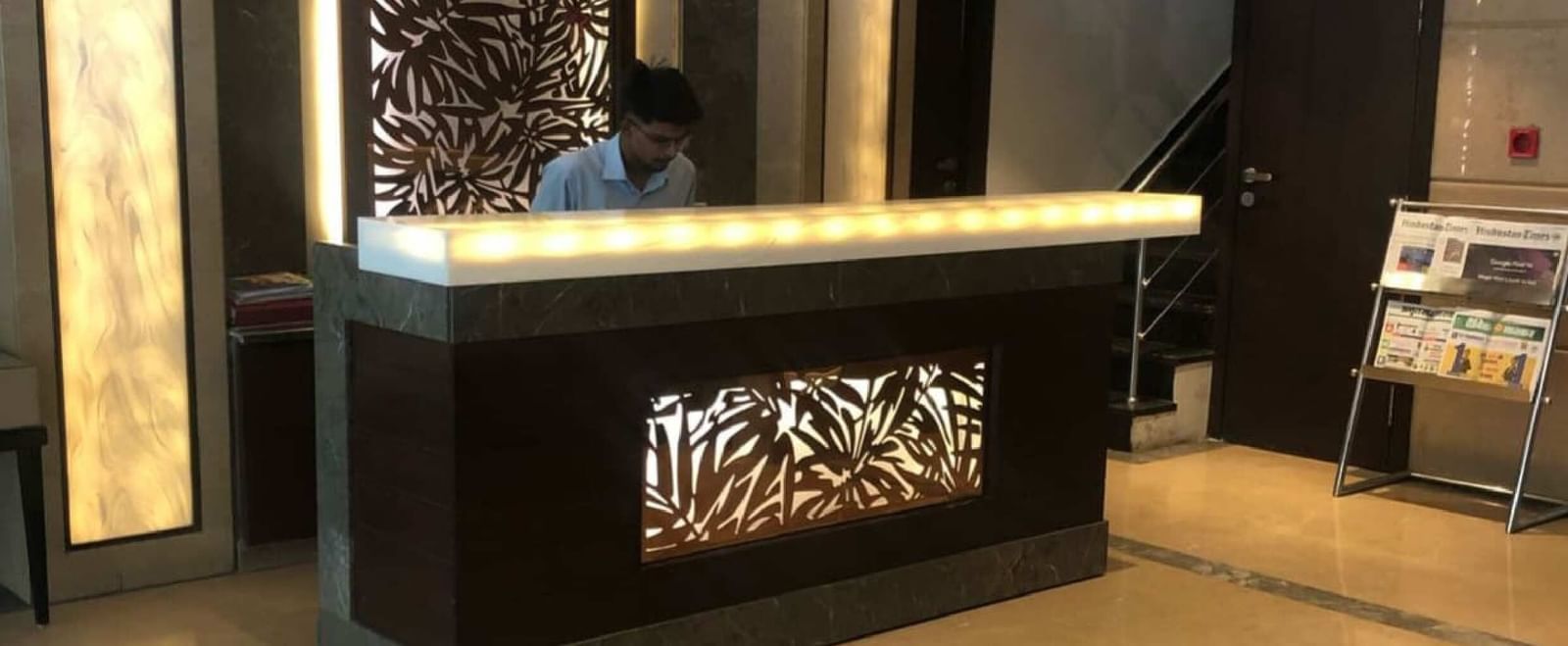 Reception desk at BluSalzz Select - City Centre, Amritsar with modern décor and warm lighting.