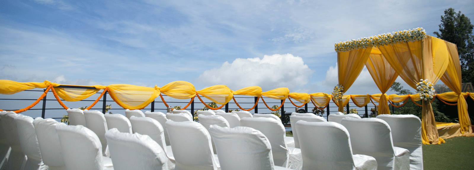 An image of the open banquet space with chairs and decoration - Great Trails Yercaud by GRT Hotels