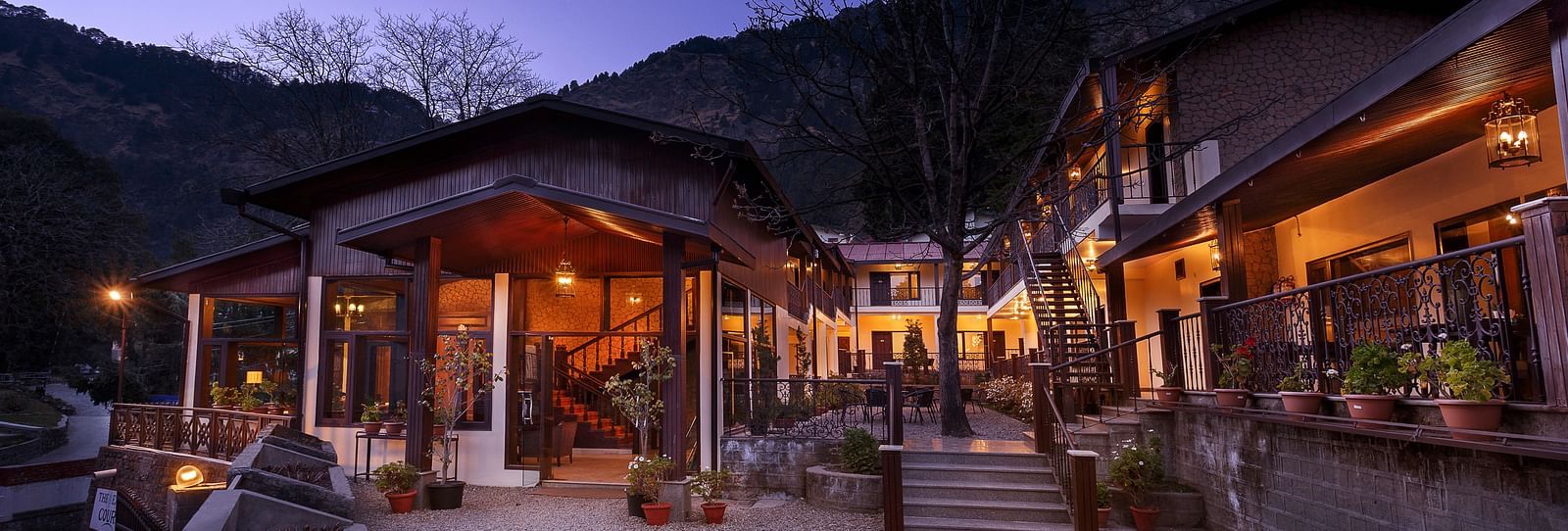Outdoor dining area at a resort with a mountain view.
