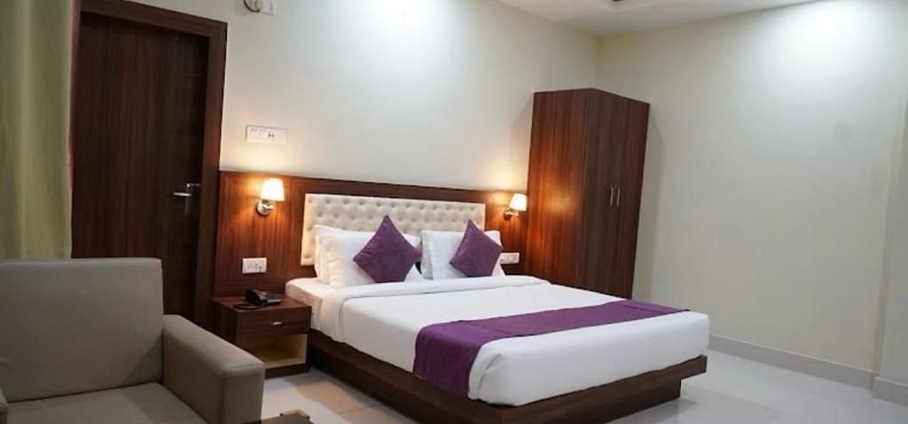 A neat and modern room with minimalist décor, soft lighting, and a warm, welcoming vibe - Pemaling Lords Eco Inn Guwahati