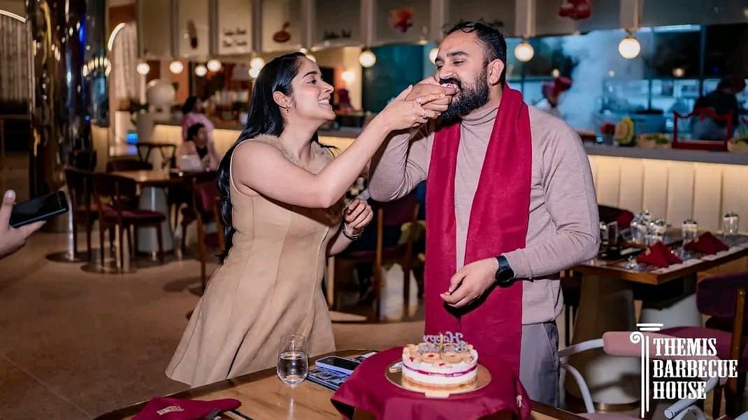 Guests celebrating a special moment by feeding cake to each other at Themis Barbecue House, Ambala