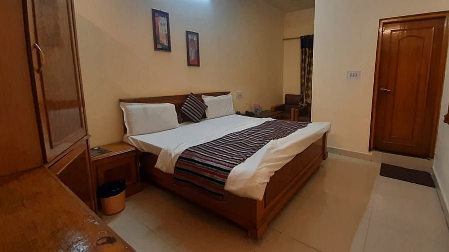 An image of a room in Roorkee with a king size bed, a cupboard and a television - Motel Divine International, Roorkee