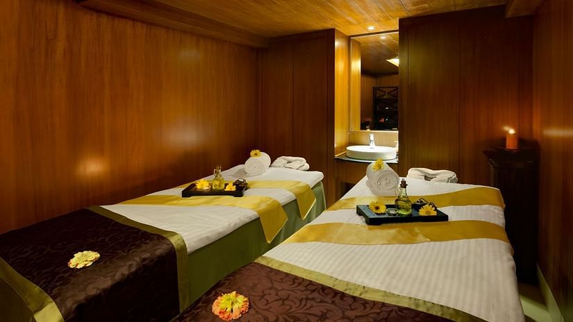 An overview of the massage tables inside the spa with towels and other things kept on it - Kenilworth resort & spa, goa