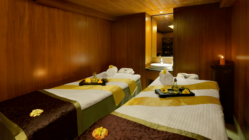 An overview of the massage tables inside the spa with towels and other things kept on it at Kenilworth Resort & Spa, Goa - A premium spa resort in South Goa