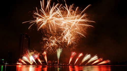 Colourful fireworks on display by the lake