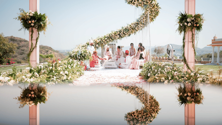 Elegant Hindu wedding ceremony with a stunning floral backdrop and a reflecting pool at Fateh Vilas Collection Udaipur