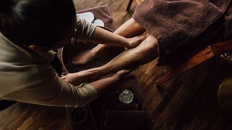 A person receiving a foot massage in a spa setting.
