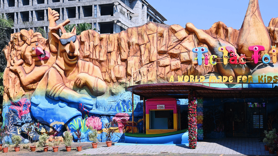 The exterior entrance of Tic Tac Tot features large sculpted animal characters and a welcoming sign.