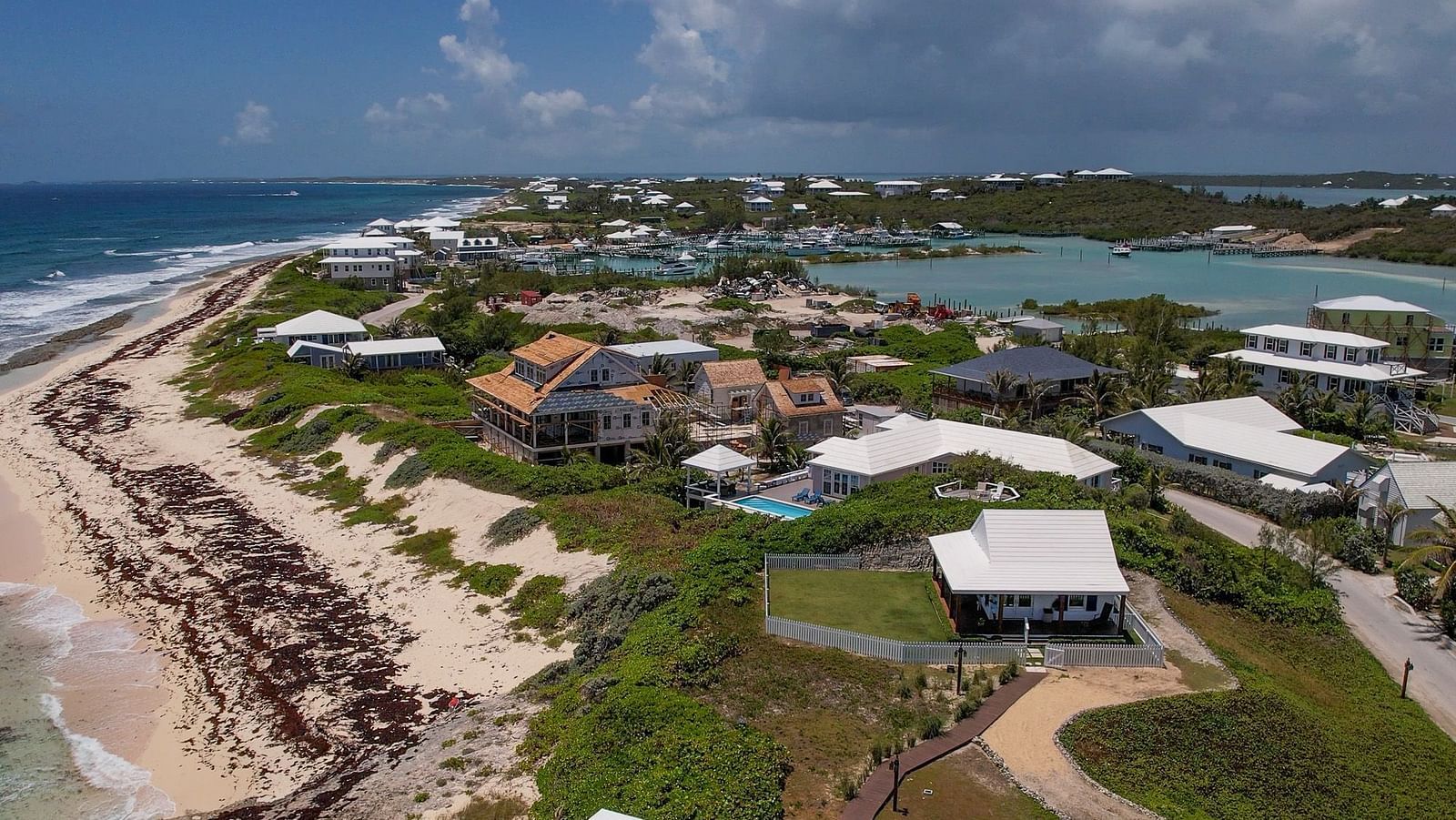 Coastal aerial shot showing Abaco Inn and surrounding cottages near the shoreline.