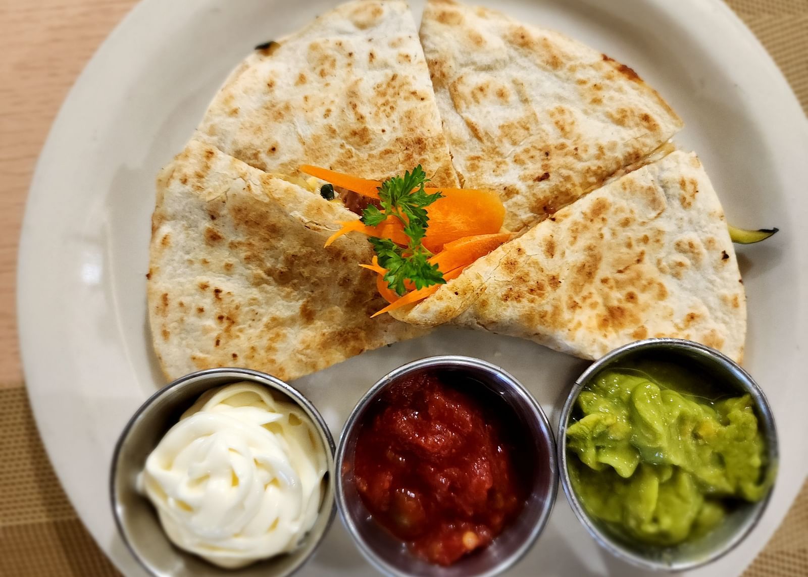 Close-up of quesadilla with salsa, sour cream, and guacamole trio - Hotel 39, Jamaica