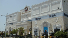 A facade view of Chennai City Centre Mall with the road in front of it