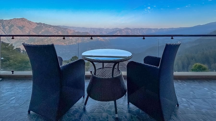 Terrace dining with majestic mountain and valley views under a twilight sky at Aranya Himalayan Retreat, Mashobra