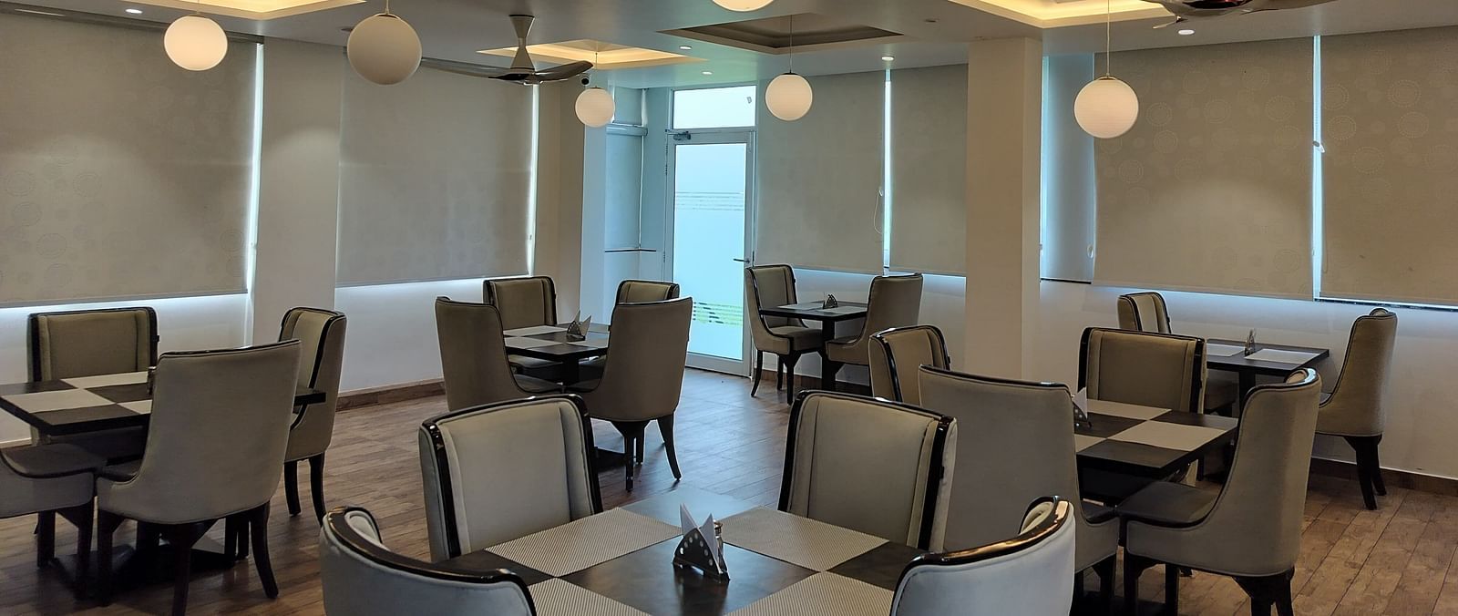 full view image of the dining area at panther's perch with window shades rolled down - Eminence The Corbett