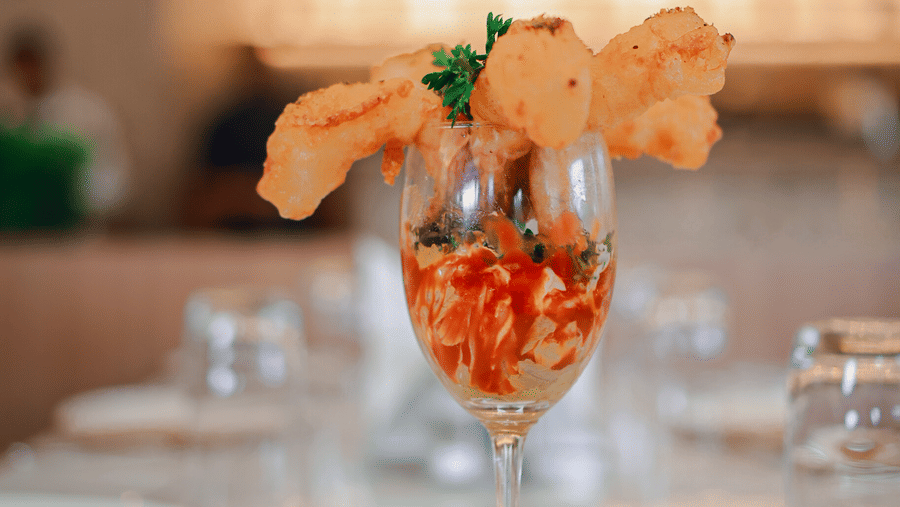Dessert served in a glass with blurred restaurant interiors at Hotel Mumbai House Digha, Airoli.
