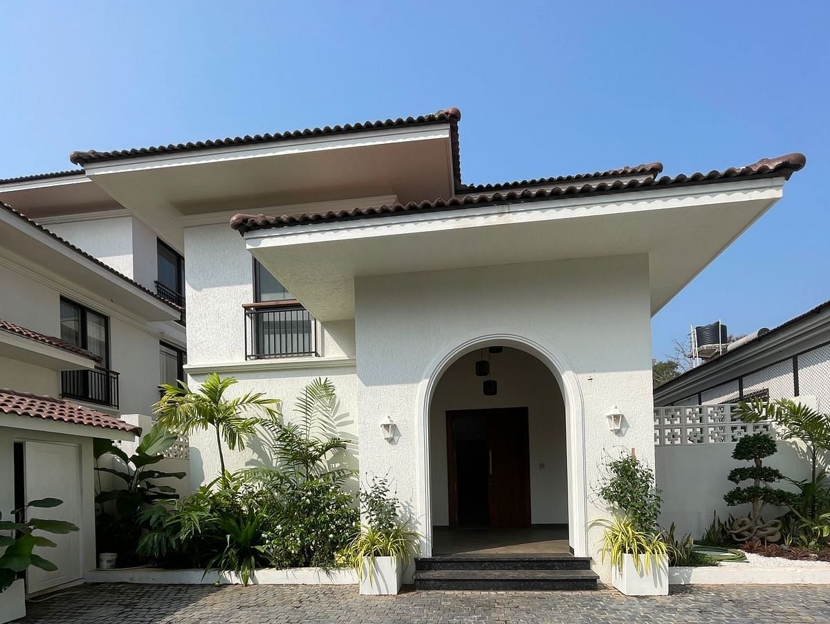 The front view of a modern house with a well-maintained driveway and neatly trimmed greenery surrounding the entrance - BluSalzz Villas - Alocassia, Anjuna.