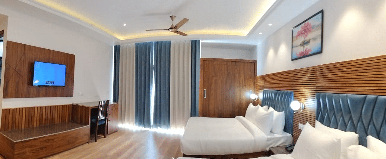 A view through the sofa of a two large beds in Family Suite Room at DLS Ark Holiday Inn, Banikhet.