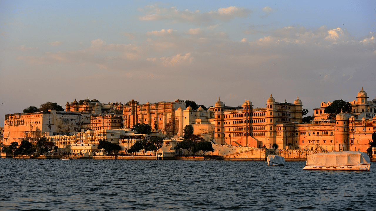 Buildings along a lake, seen from the water with historic structures lining the shore.