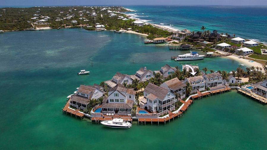 Aerial view of luxurious waterfront houses with private docs, boats docked nearby at Abaco Inn.