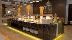 Modern buffet restaurant with live counters and seating at Park Plaza, Ludhiana.