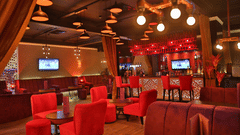 Passion Lounge interior with plush seating, warm lighting and a vibrant ambience, ideal for relaxed evenings, drinks and casual conversations.