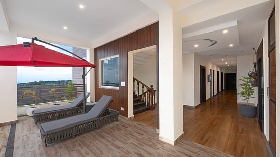 loungers next to the staircase with a canopy above - Stone Wood Mountain Resort, Dharamshala